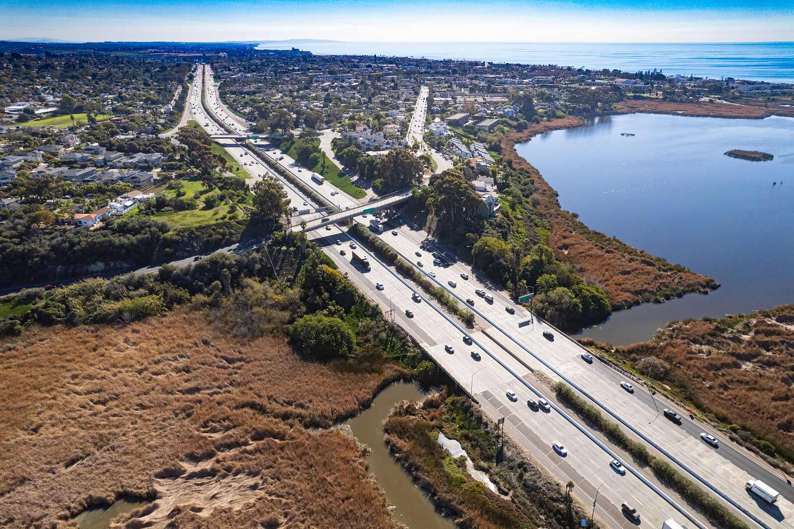 Aerial view of Interstate 5 running beside a Carlsbad lagoon