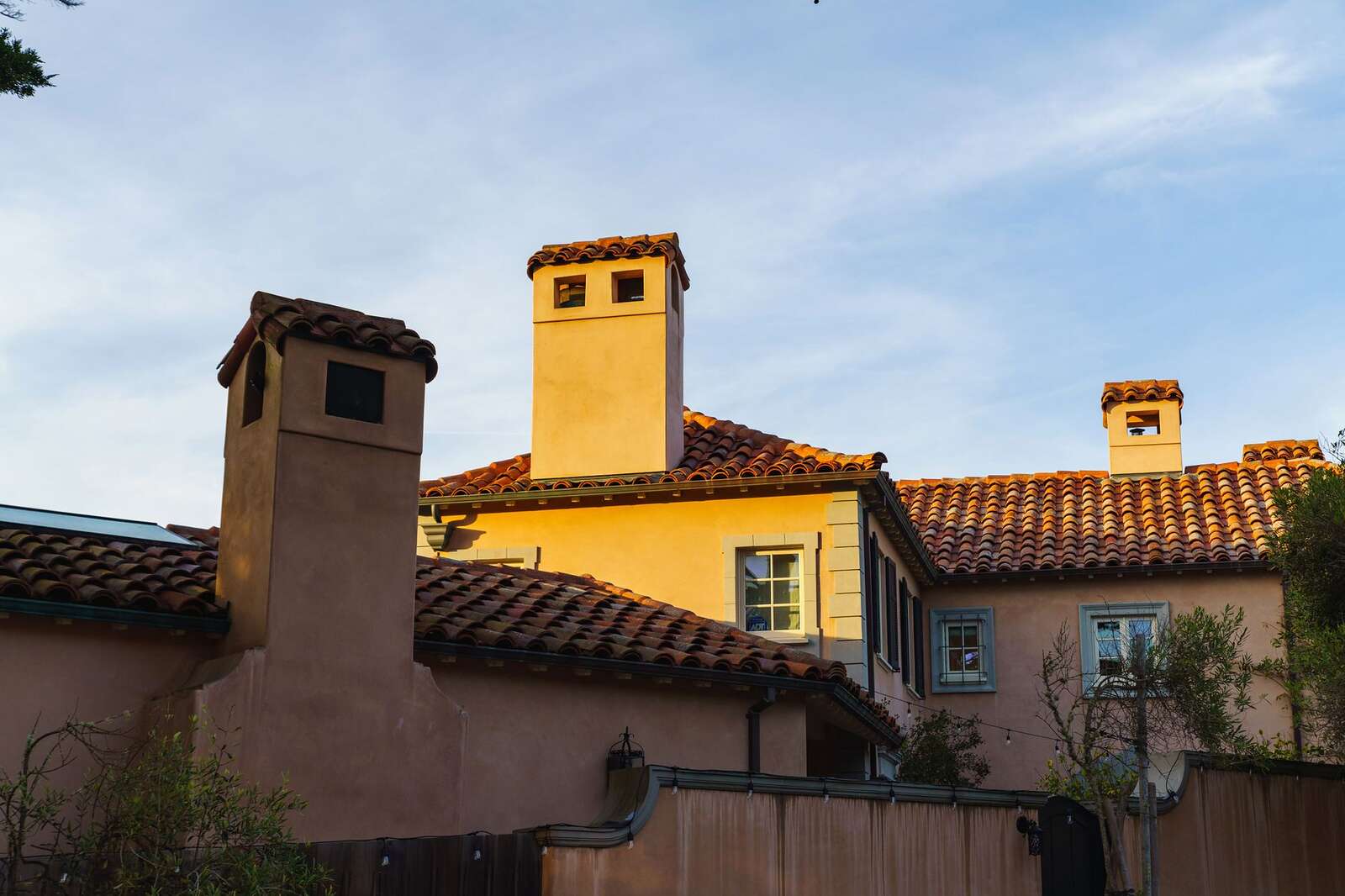 A tile-roofed house with two chimneys, the 1920s Spanish style of Kensington and Talmadge